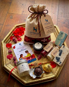 Rakhi gift potli with massage candle, solid perfume, lip balm, rakhi and akshat-kumkum